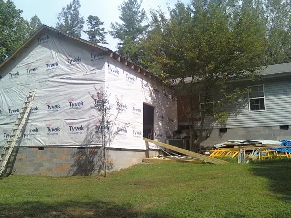 Tyvek wrapped gable on a new room addition beside an existing home in Harveysburg